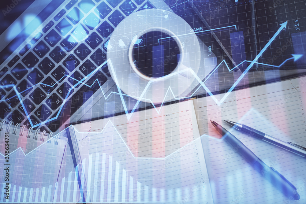 Stock market chart and top view computer on the table background. Double exposure. Concept of financial analysis.