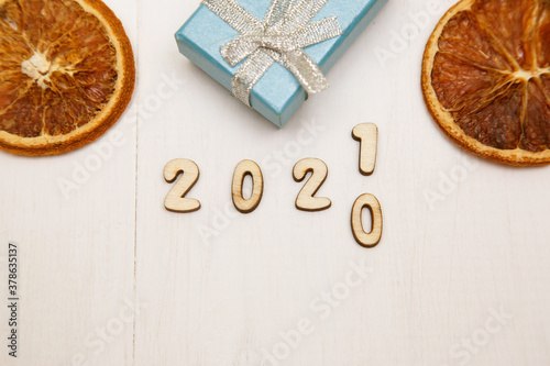 The new year 2021 replaces 2020. top view. White wooden background