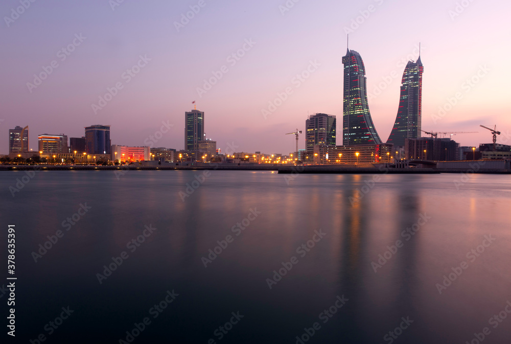 Fototapeta premium MANAMA , BAHRAIN - DECEMBER 19: Bahrain Financial Harbour with dramatic hue in the sky at dusk, December 19, 2019. It is one of tallest twin towers in Manama, Bahrain.