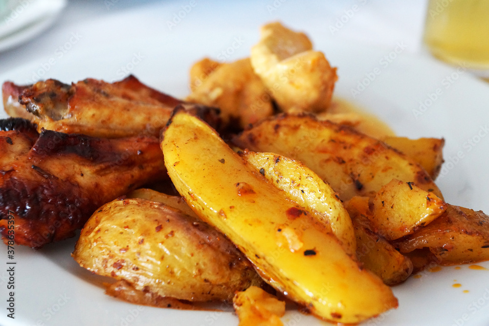 baked potatoes with meat on a white dish close-up baked potatoes with meat on a white dish close-up