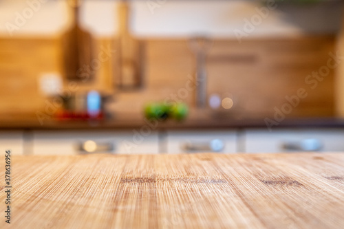 blurred kitchen and a wooden worktop