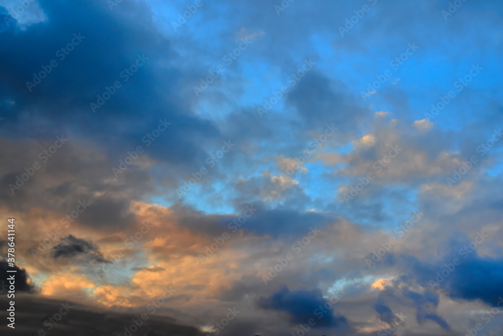 blue twilight sky covered by orange shaded clouds covering the horizon.