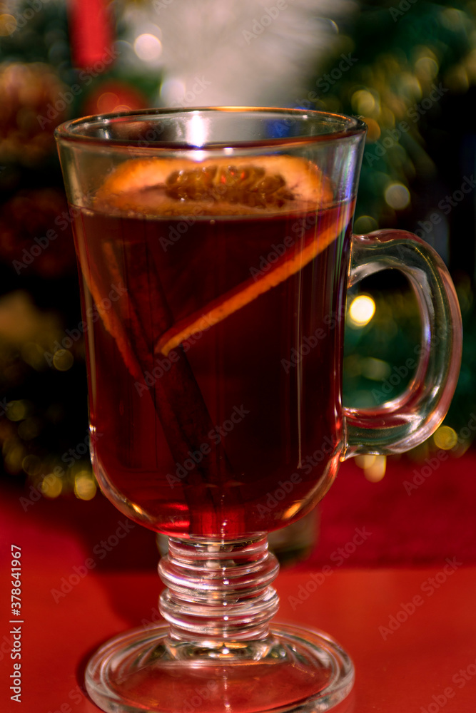 Winter drink. Mulled wine with cherries in a beautiful mug on a red background. Winter drink. Mulled wine with cherries in a beautiful mug on a red background.
