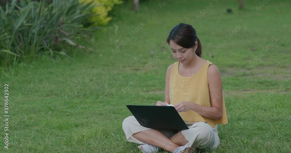 Woman use of earphone for a video call on laptop Woman use of earphone for a video call on laptop