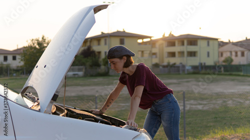 A woman looking at her car.