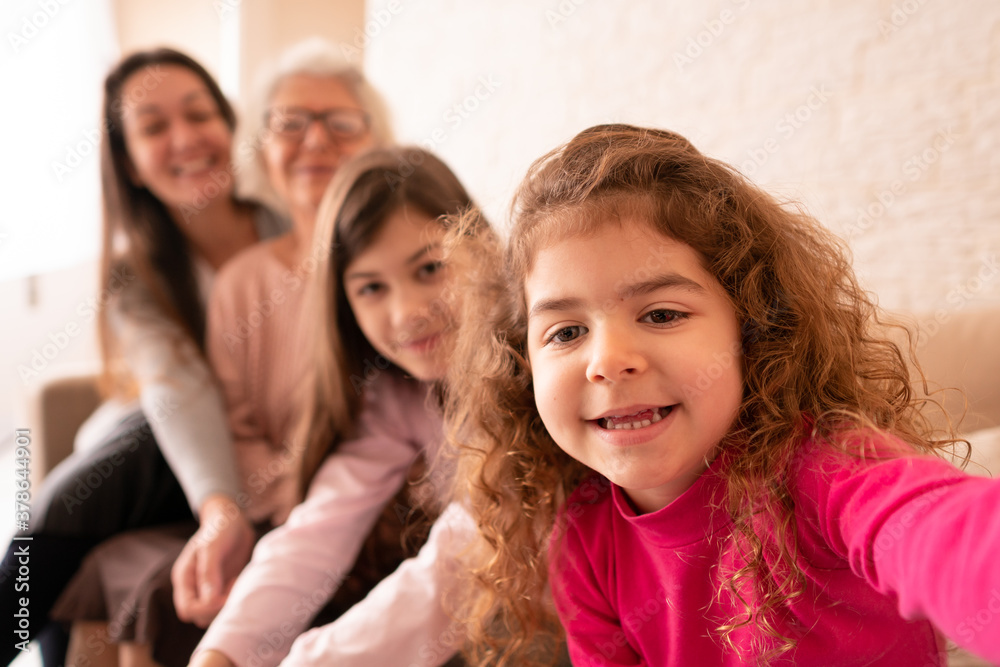 Joyful brazilian multigenerational family with smart phonetaking a self portrait. at family home. Togetherness, family, support concept. Joyful brazilian multigenerational family with smart phonetaking a self portrait. at family home. Togetherness, family, support concept.