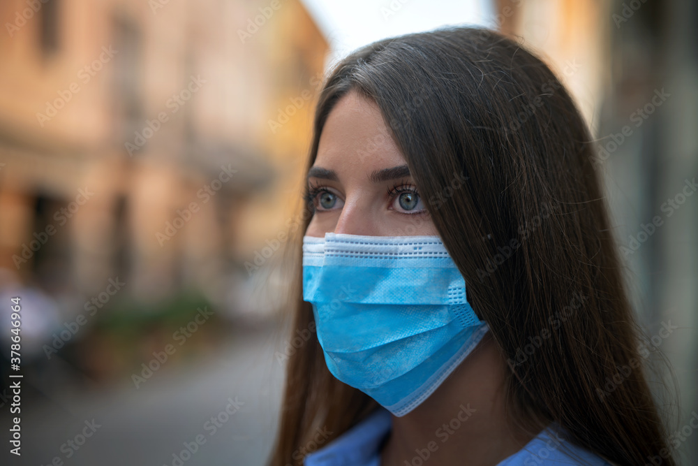 Authentic shot of young woman is wearing a medical mask to protect herself from disease in city center. Authentic shot of young woman is wearing a medical mask to protect herself from disease in city center.