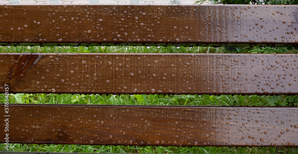 Drops of water on wooden bench after the rain, natural weather background Drops of water on wooden bench after the rain, natural weather background