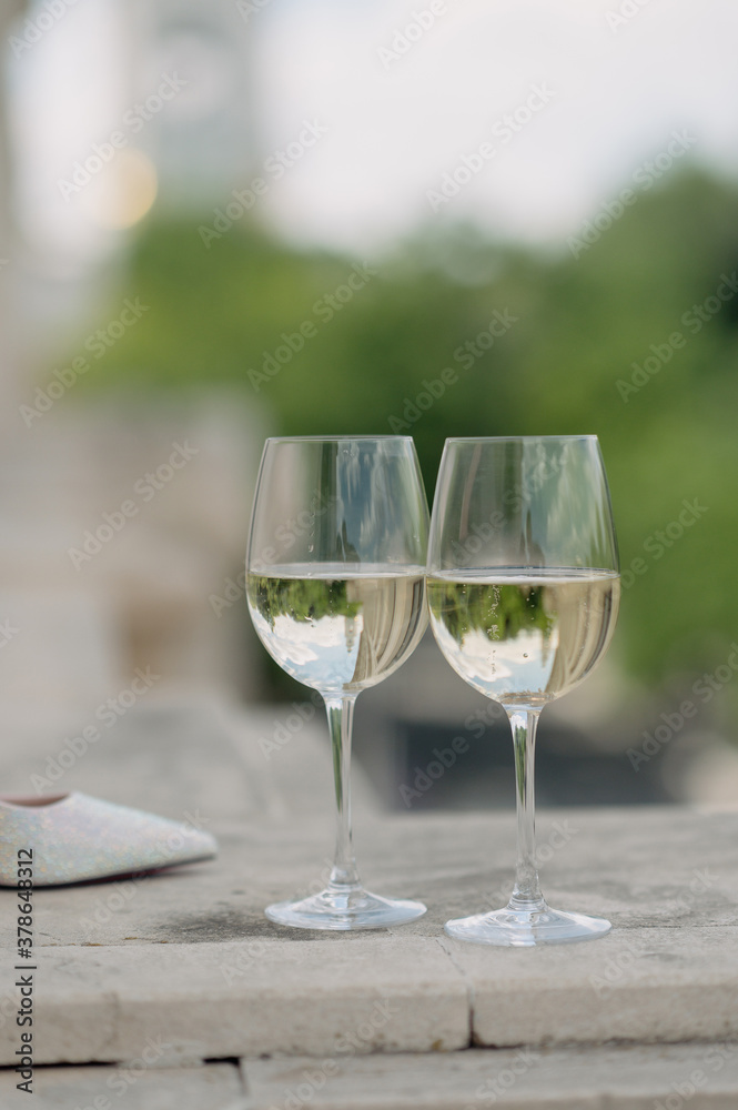 Wedding accessories. Two glasses of champagne, a bouquet of flowers and shoes Wedding accessories. Two glasses of champagne, a bouquet of flowers and shoes
