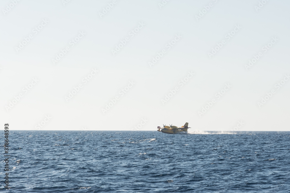 propeller firefighters plane taking water from the sea propeller firefighters plane taking water from the sea