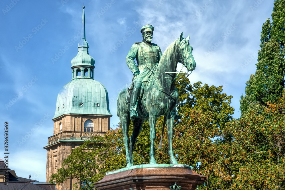 Darmstadt, Monument of Ludwig IV on Friedensplatz with the tower of Hessian State Museum (Hessisches Landesmuseum) in the background