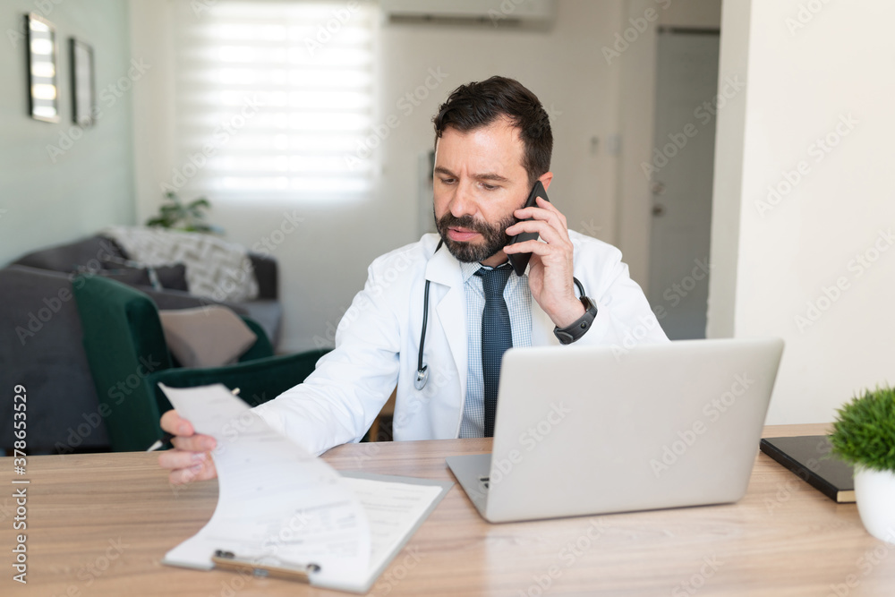 Doctor talking to patient on the phone Doctor talking to patient on the phone
