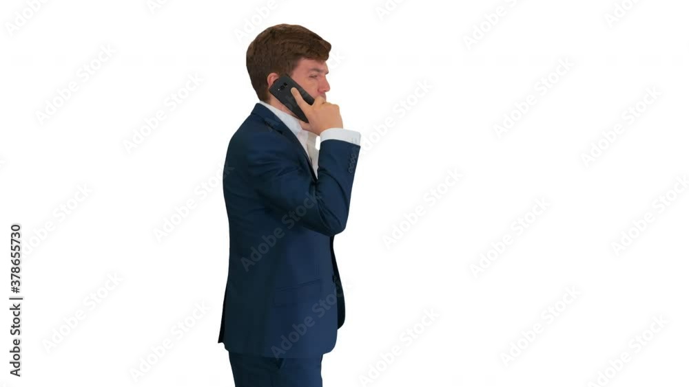 Handsome young businessman talking on the phone while walking on white background. Handsome young businessman talking on the phone while walking on white background.