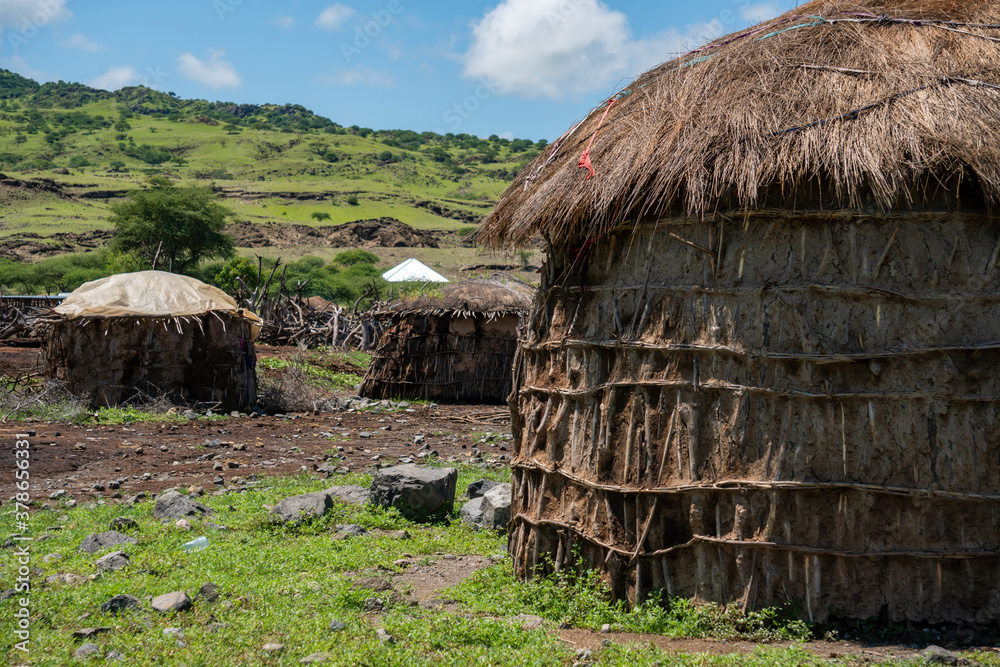 Traditional Maasai Village with Clay Round Huts in Engare Sero area near Lake Natron and Ol Doinyo Lengai volcano in Tanzania, Africa Traditional Maasai Village with Clay Round Huts in Engare Sero area near Lake Natron and Ol Doinyo Lengai volcano in Tanzania, Africa