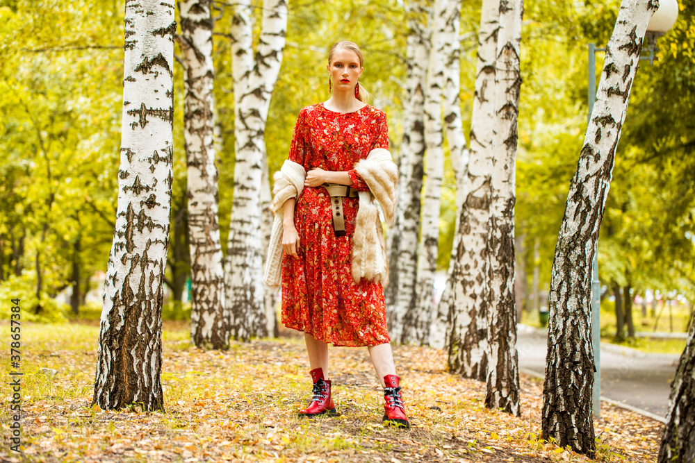 Fashion model. Young blonde woman in red dress