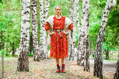 Fashion model. Young blonde woman in red dress