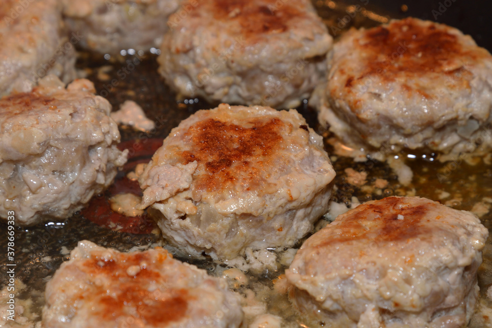 Meat cutlets are fried in frying pan. Meat cutlets are fried in frying pan.