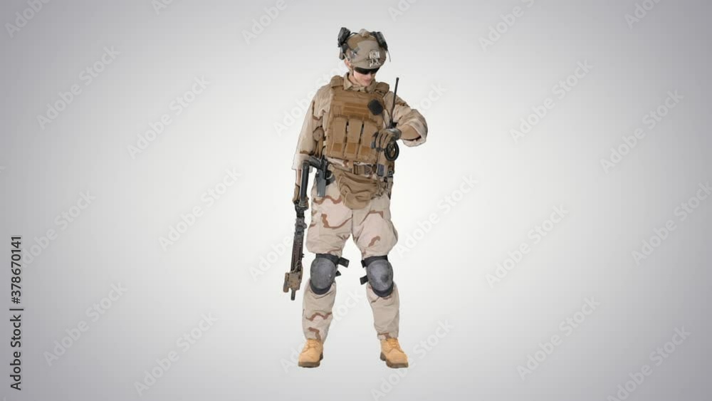 Marine standing and checking his uniform on gradient background. Marine standing and checking his uniform on gradient background.