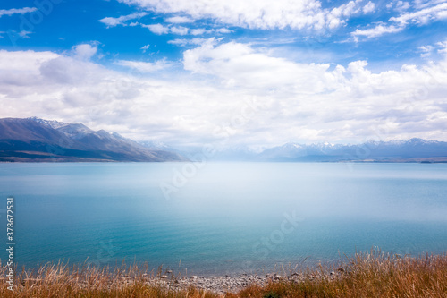 Foggy morning at Lake Pukaki. The alpine lake is famous for the amazing turquoise hues of the water and sharp mountain ranges in New Zealand  South Island.