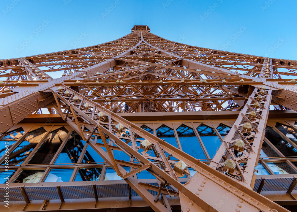 A view of one side of the Eiffel Tower from the bottom