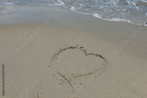 Love on the beach drawn in the sand landscape