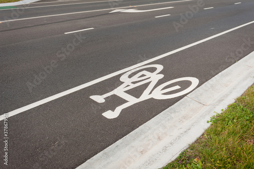 Bicycle Sign on the Road. Asphalt Road with green lane for bicycles.