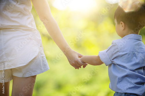 Mother holding baby hand