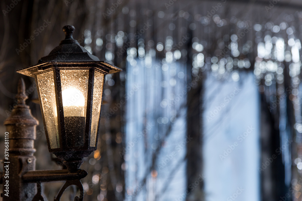 Vintage frosty lamppost. Light in the night Christmas city.