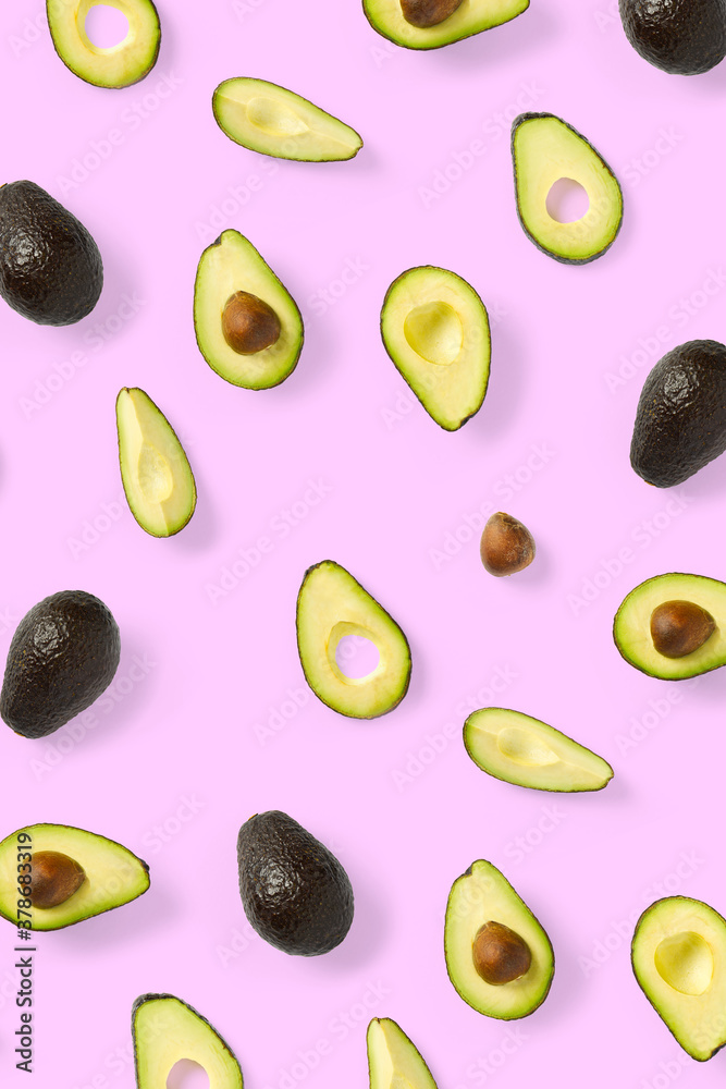Avocado. Background made from isolated Avocado pieces on pink background. Flat lay of fresh ripe avocados and avacado pieces. Avocado. Background made from isolated Avocado pieces on pink background. Flat lay of fresh ripe avocados and avacado pieces.
