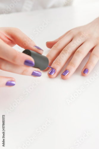 woman painting fingernails