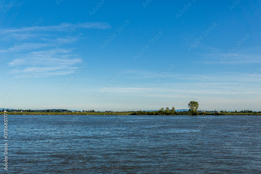 afternoon time at the Fraser River seen from shore at in Richmond British Columbia Canada afternoon time at the Fraser River seen from shore at in Richmond British Columbia Canada