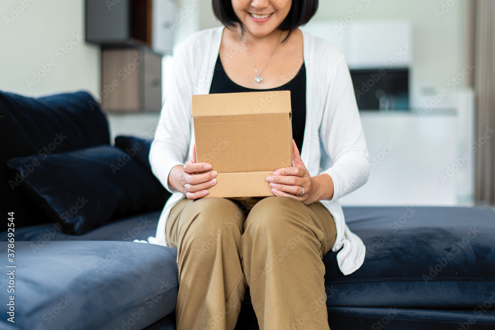Happy asian woman opening a gift box at home,Surprise day Happy asian woman opening a gift box at home,Surprise day