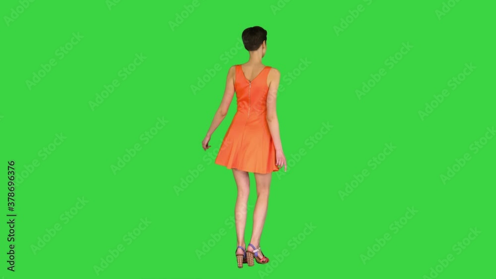 Girl Dancing in Orange SunDress on a Green Screen, Chroma Key. Girl Dancing in Orange SunDress on a Green Screen, Chroma Key.