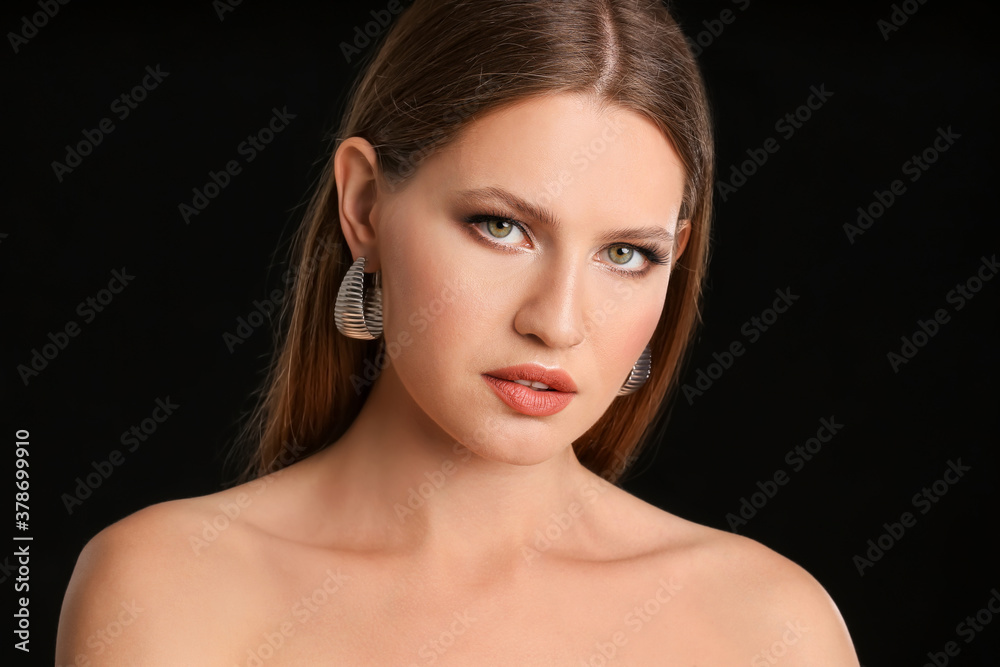 Young woman with beautiful eyeshadows on dark background
