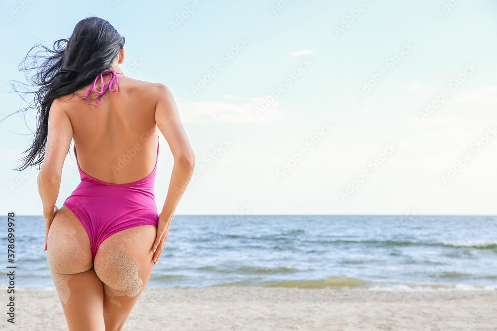 Beautiful young woman in swimsuit on sea beach Beautiful young woman in swimsuit on sea beach