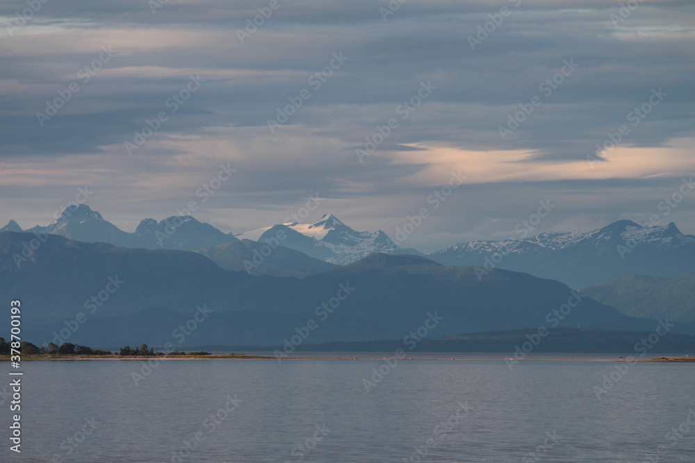 Cloud Movement at Sunset Scenically over Snowcapped Mountains