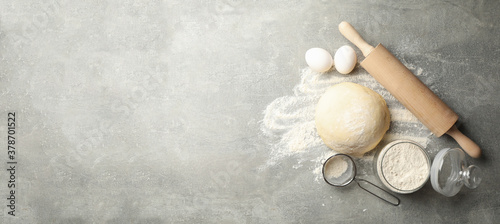 Concept for baking with dough on gray background