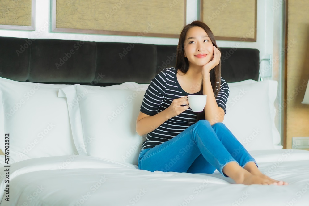 Portrait beautiful young asian woman smile relax on bed