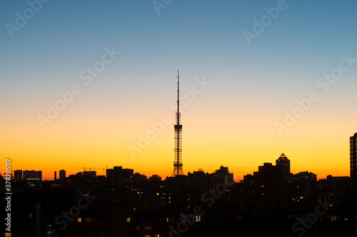Silhouette of a TV tower on a background of clear sky on sunset, silhouette of the cityscape. Kyiv TV Tower, Kyiv, Ukraine.