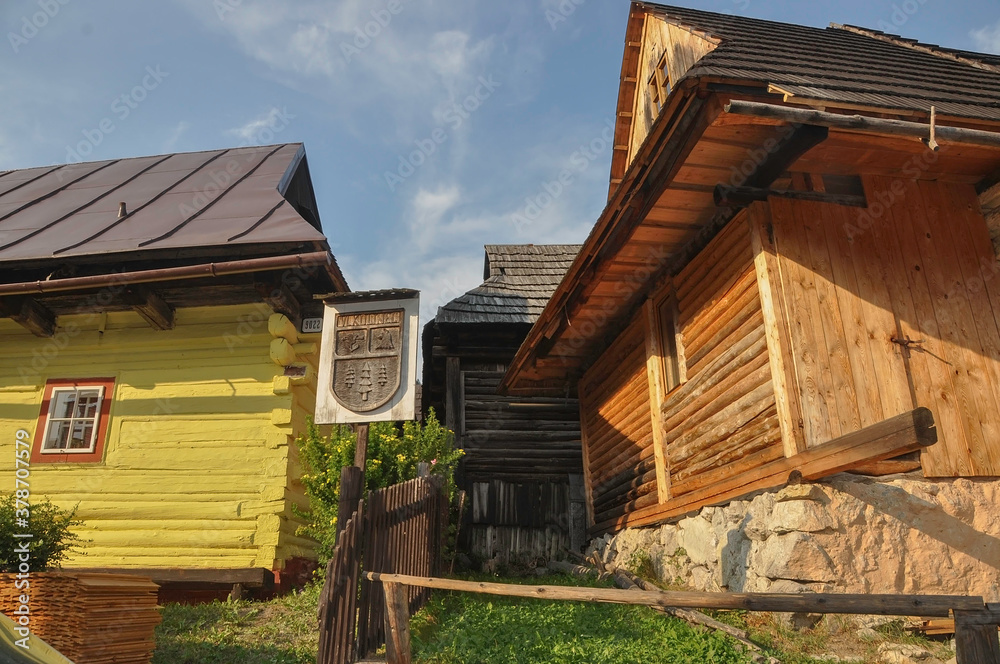 VLKOLINEC, SLOVAKIA, EUROPE, SUMMER 2015. Beautiful street in the center of the Unesco heritage village of Vlkolinec with the name of the village on a wooden sign. The houses are made of wood