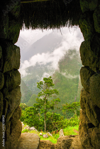 The magical mountain of Machu Pichu, in Peru, with twists and turns of clouds between its peaks.