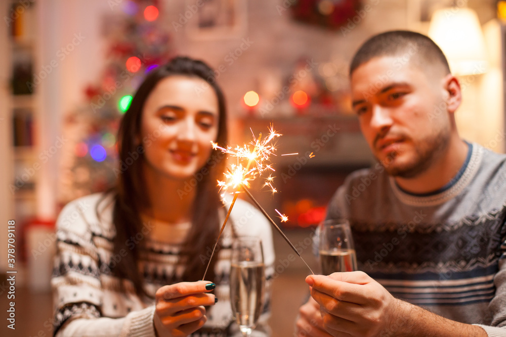 Happy couple on christmas day holding hand fireworks. Happy couple on christmas day holding hand fireworks.