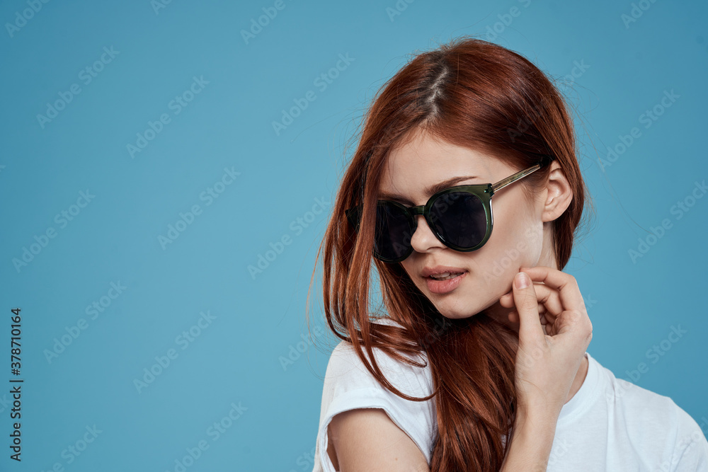 Pretty woman in sunglasses charm long hair white t-shirt blue background