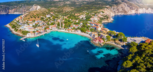 Aerial view to the little village of Asos on the island of Kefalonia, Greece, surrounded by turquoise sea and green hills with Pine Trees