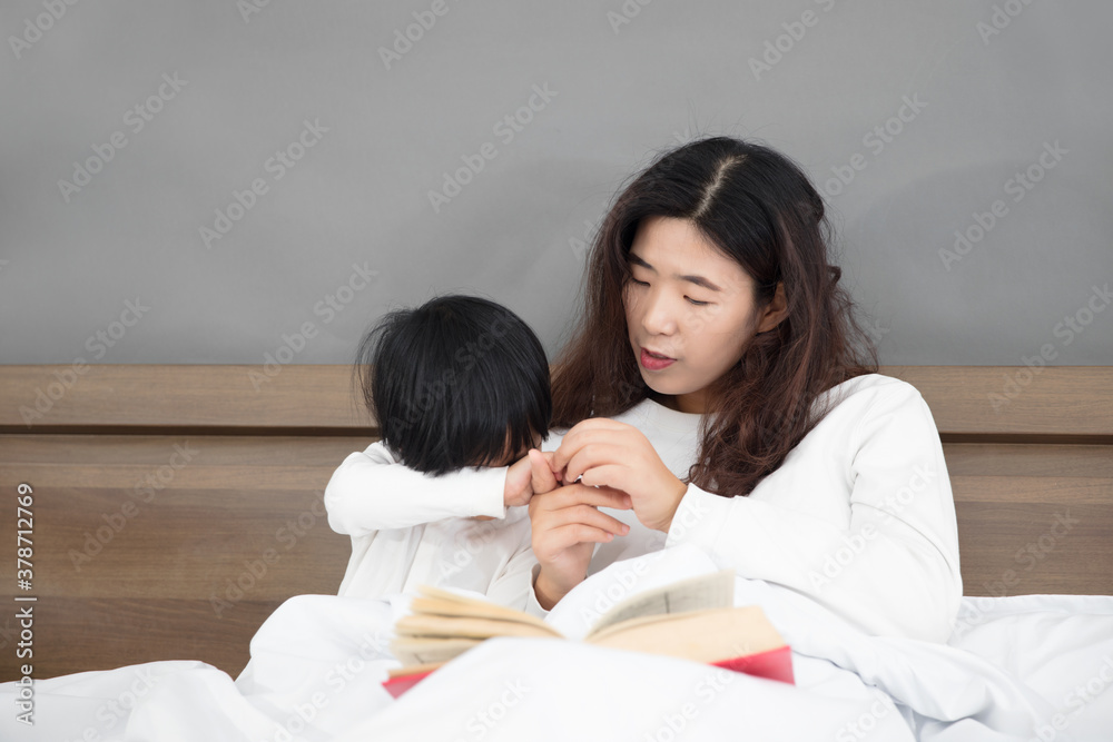 Mother and daughter getting up early in bed Mother and daughter getting up early in bed