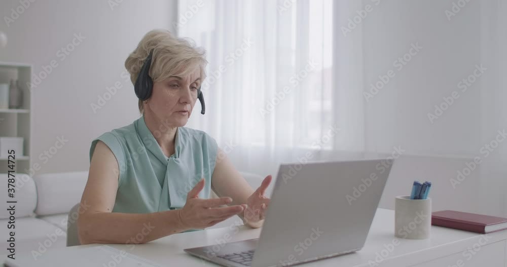experienced online consultant woman is talking online with client by video chat at laptop, working remotely from home experienced online consultant woman is talking online with client by video chat at laptop, working remotely from home