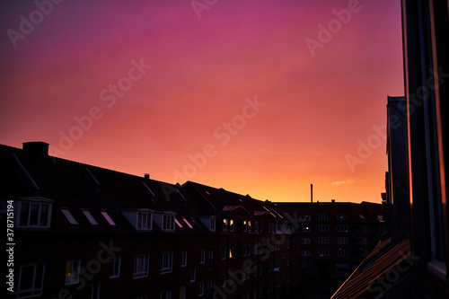 Magical purple and red sunset over rooftops