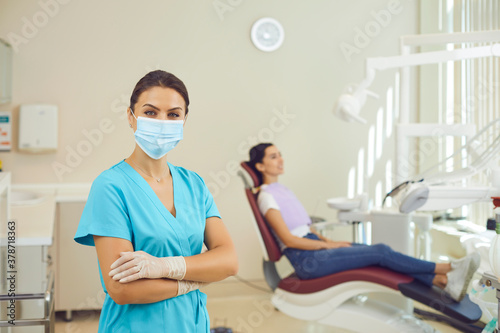 Doctor dentist standing and looking at camera in dental clinic during examination