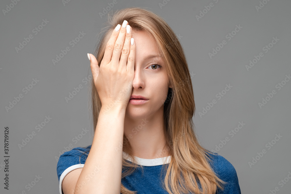 Young female covers face hand, feels fatigue, needs good rest. Human emotions, facial expression concept Young female covers face hand, feels fatigue, needs good rest. Human emotions, facial expression concept