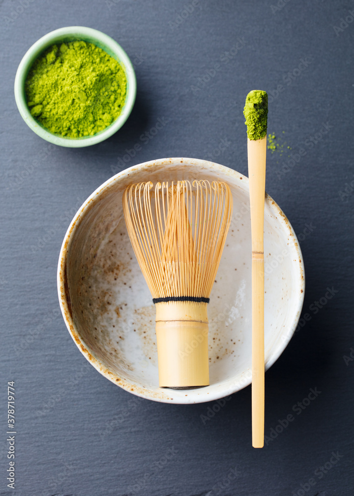 Matcha, green tea ceremony set, bowl, bamboo whisk and spoon. Grey background. Top view. Matcha, green tea ceremony set, bowl, bamboo whisk and spoon. Grey background. Top view.